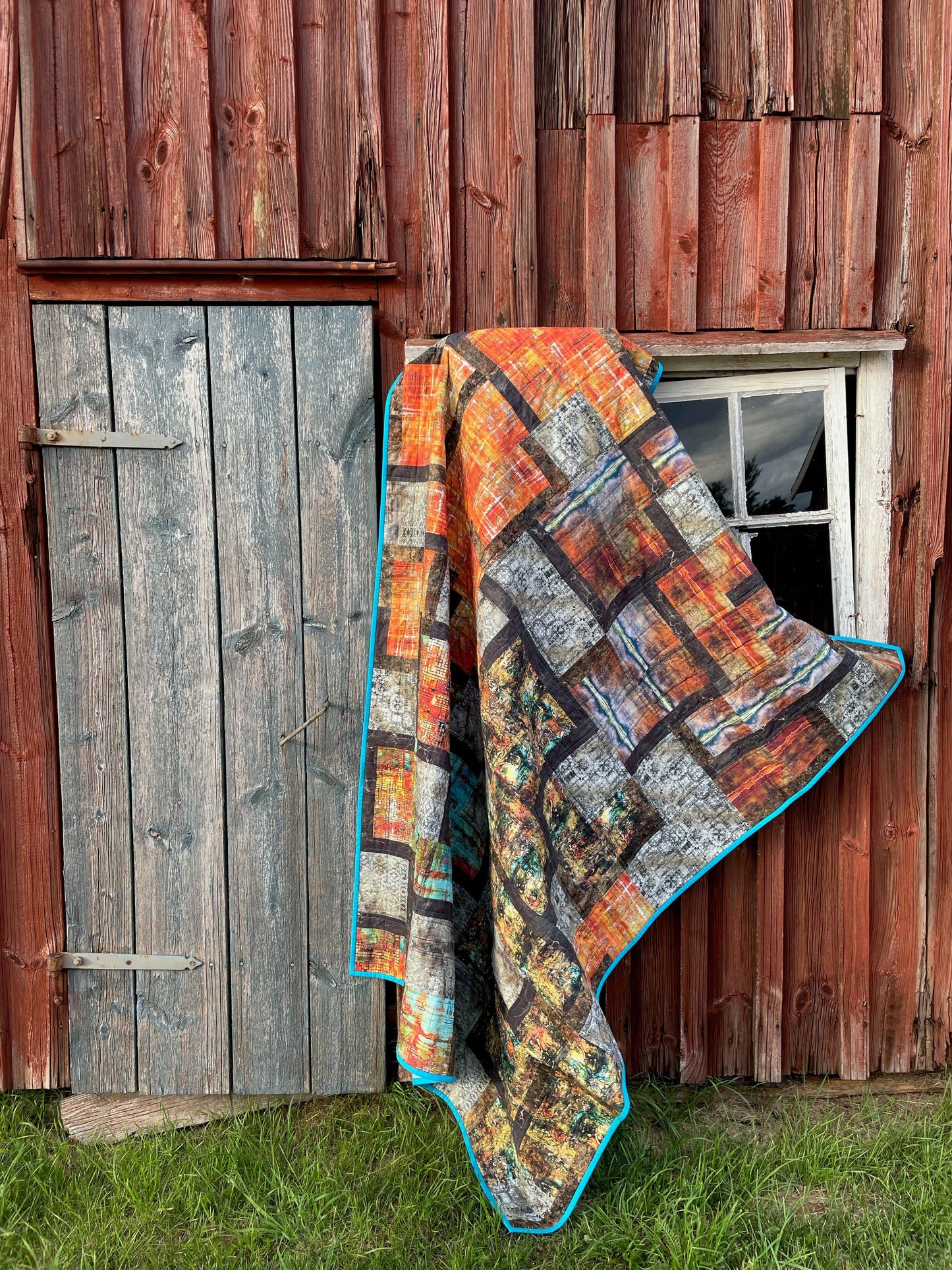 Quilt hanging on vintage barn.