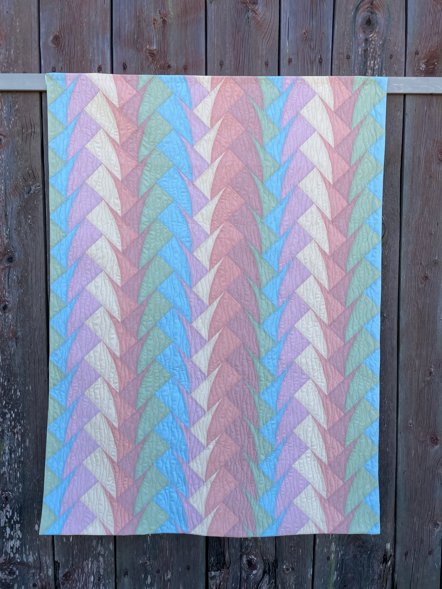 Quilt against wooden background