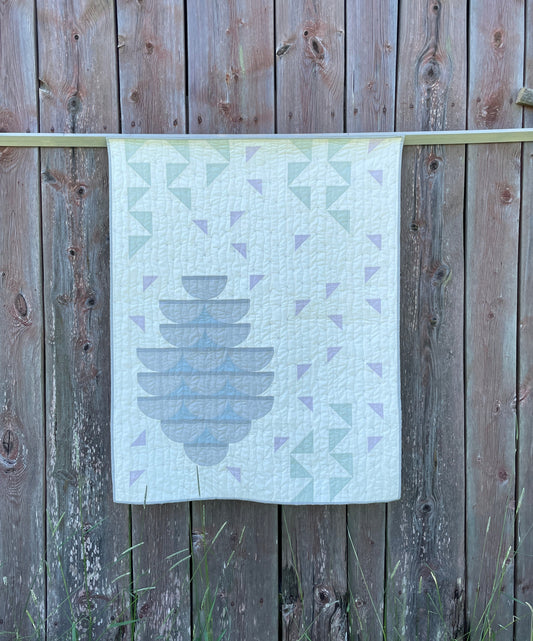 Quilt with an old barn as background