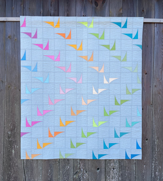 Quilt against old barn