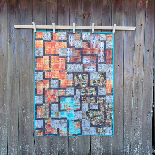 quilt against vintage barn