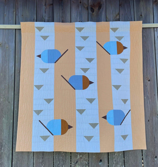 Quilt featuring blue birds.
