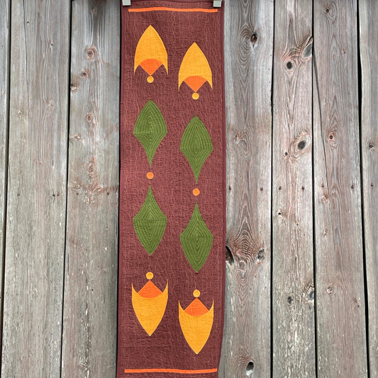Table runner with an old barn as background.