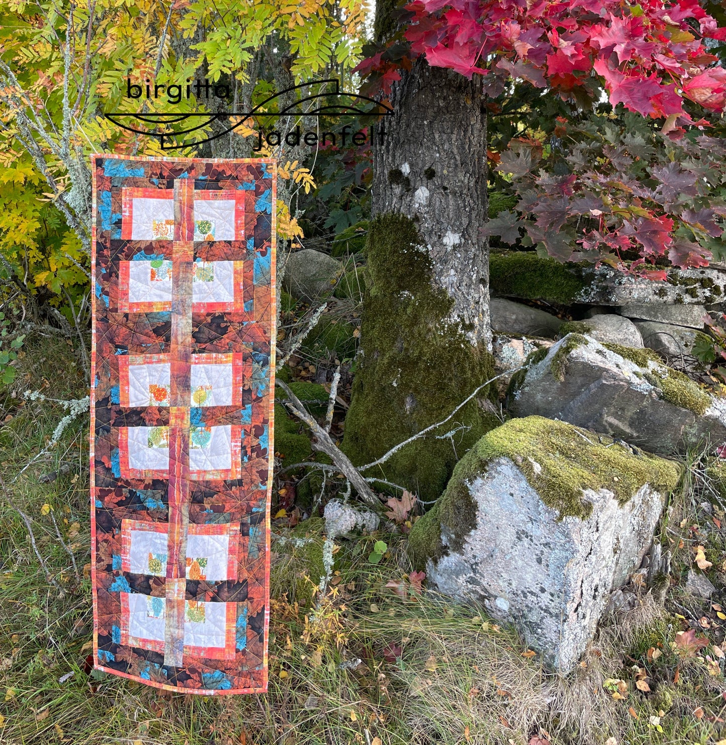 Quilt against tree and stones